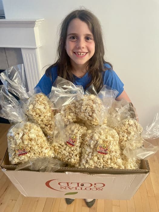A girl with bags of popcorn she made to sell